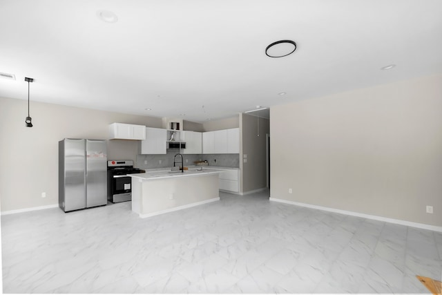 kitchen featuring pendant lighting, stainless steel appliances, sink, a center island with sink, and white cabinets