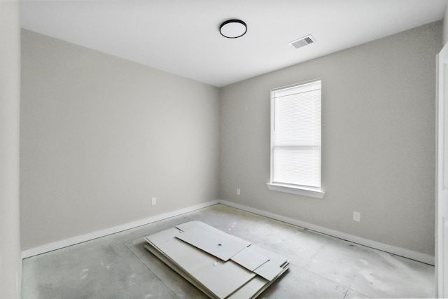 unfurnished room featuring concrete floors