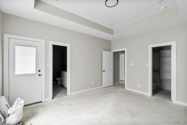 unfurnished bedroom featuring a walk in closet and ensuite bathroom