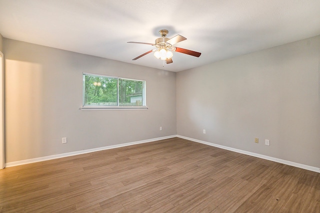 spare room with ceiling fan and wood-type flooring