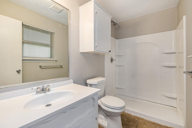 full bath featuring toilet, visible vents, vanity, a shower stall, and tile patterned floors