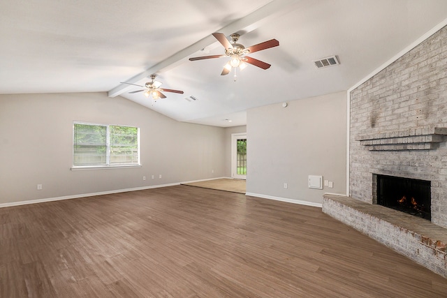 unfurnished living room with ceiling fan, lofted ceiling with beams, hardwood / wood-style flooring, and a fireplace