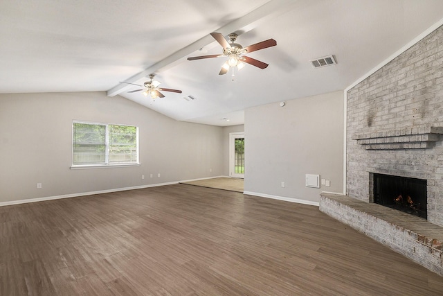 unfurnished living room with lofted ceiling with beams, a fireplace, visible vents, and dark wood-type flooring