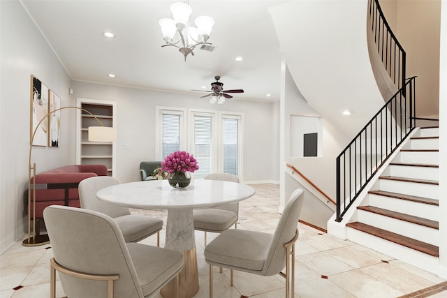 tiled dining space with ceiling fan with notable chandelier and ornamental molding