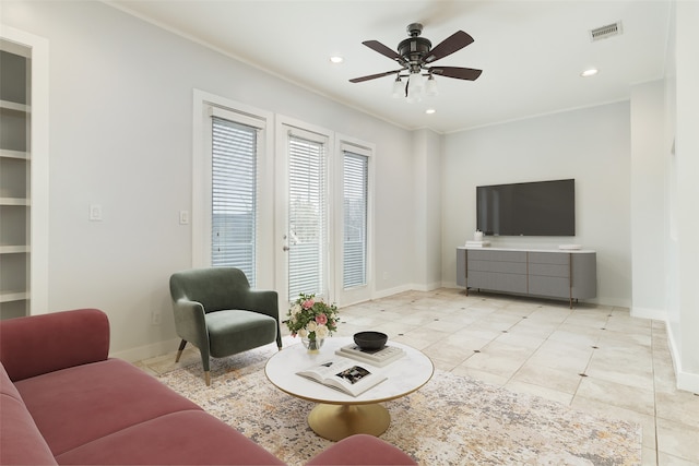 living room with built in features, light tile patterned flooring, and ceiling fan