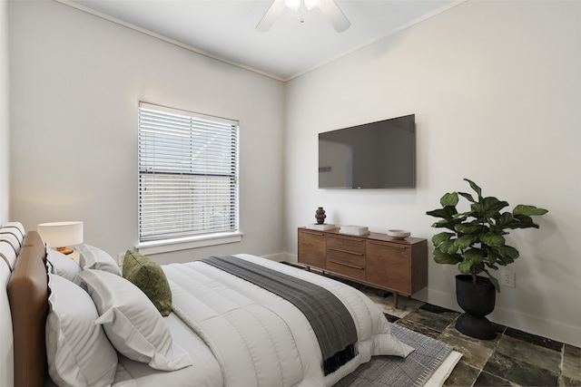 bedroom with ceiling fan and ornamental molding