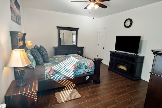 bedroom with ceiling fan and dark hardwood / wood-style flooring