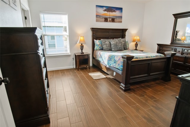 bedroom with dark hardwood / wood-style floors