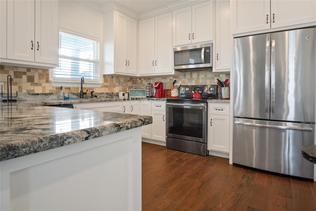 kitchen featuring white cabinets, stainless steel appliances, dark hardwood / wood-style flooring, and stone counters