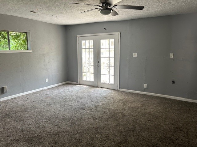 empty room with french doors, a healthy amount of sunlight, ceiling fan, and carpet floors