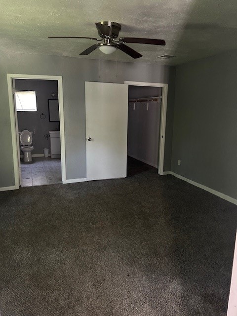 carpeted spare room featuring a textured ceiling and ceiling fan