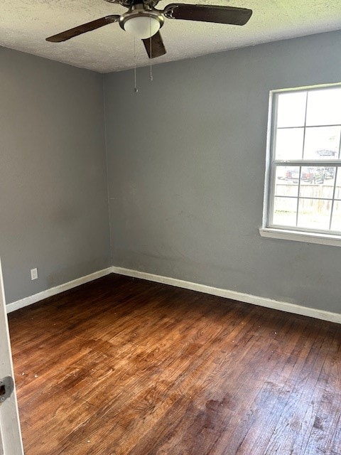 unfurnished room featuring ceiling fan, wood-type flooring, and a textured ceiling