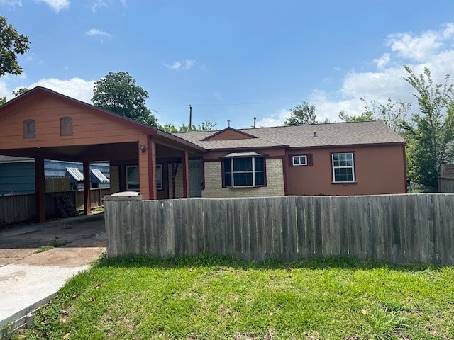 rear view of house with a yard