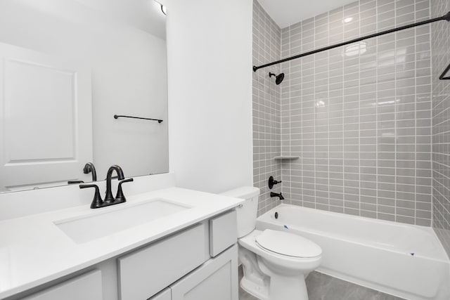 full bathroom featuring vanity, toilet, and tiled shower / bath