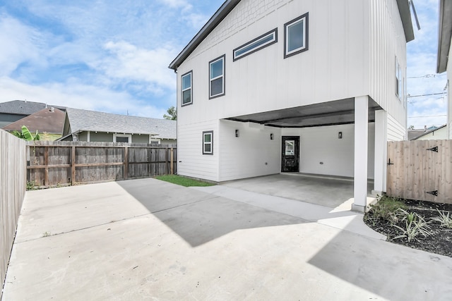 rear view of property with a carport