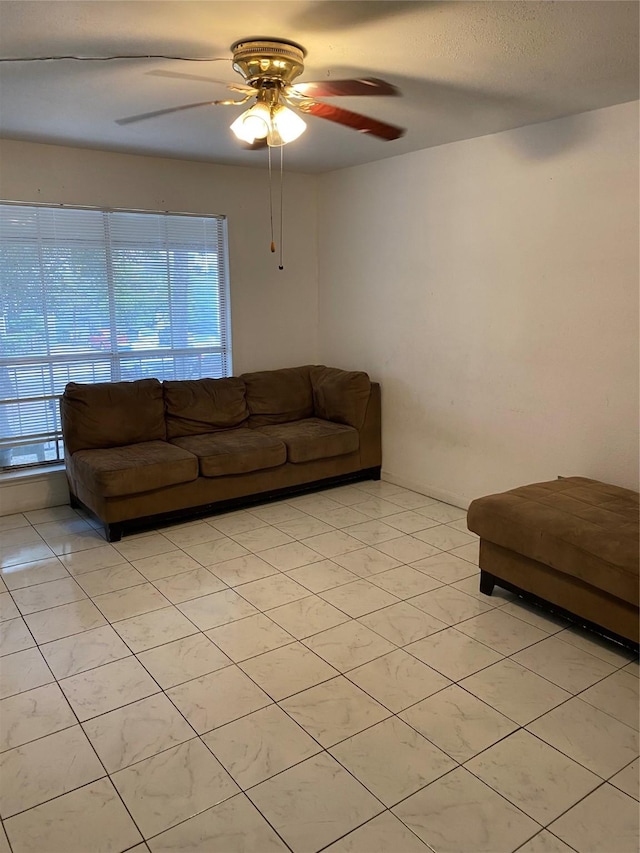 unfurnished living room featuring light tile patterned floors, ceiling fan, and a wealth of natural light