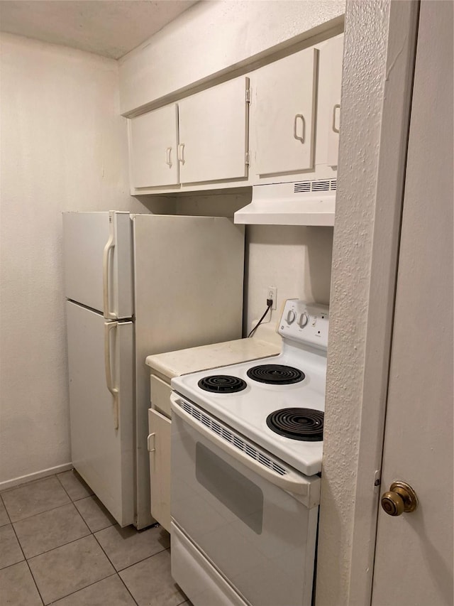 kitchen featuring white appliances, light tile patterned floors, white cabinets, light countertops, and under cabinet range hood