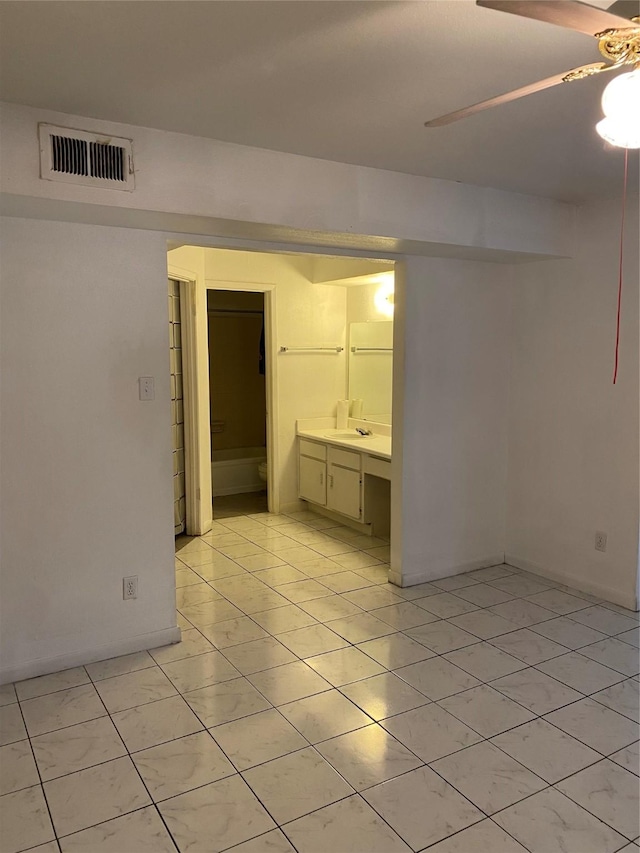 spare room with light tile patterned floors, ceiling fan, and visible vents