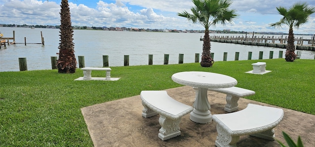 view of yard with a boat dock and a water view