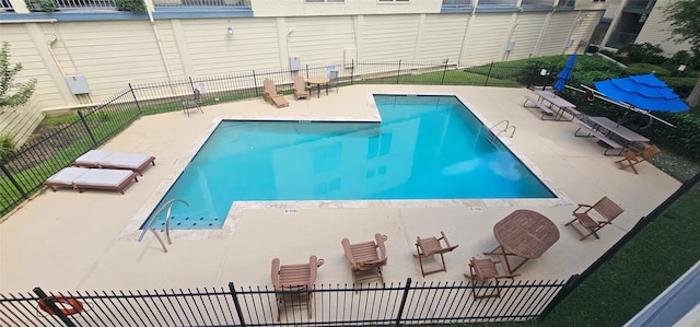 view of swimming pool with a patio area