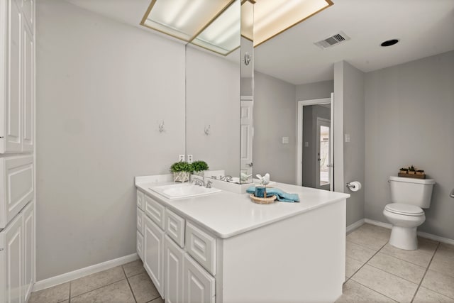 bathroom featuring tile patterned floors, vanity, and toilet