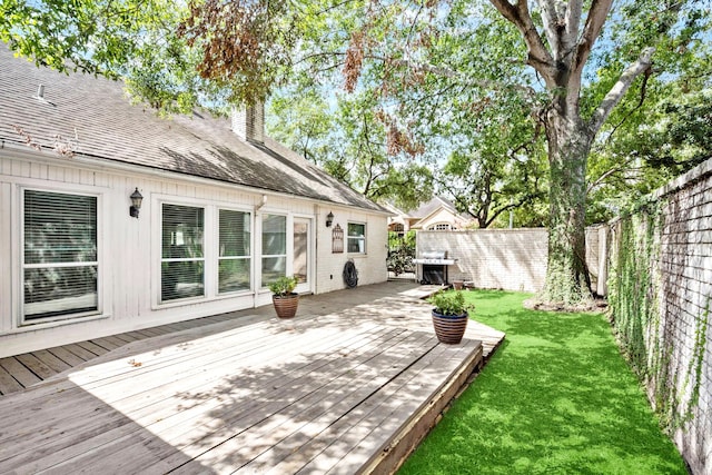 wooden deck with a lawn