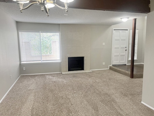 unfurnished living room featuring carpet floors, a textured ceiling, and a brick fireplace