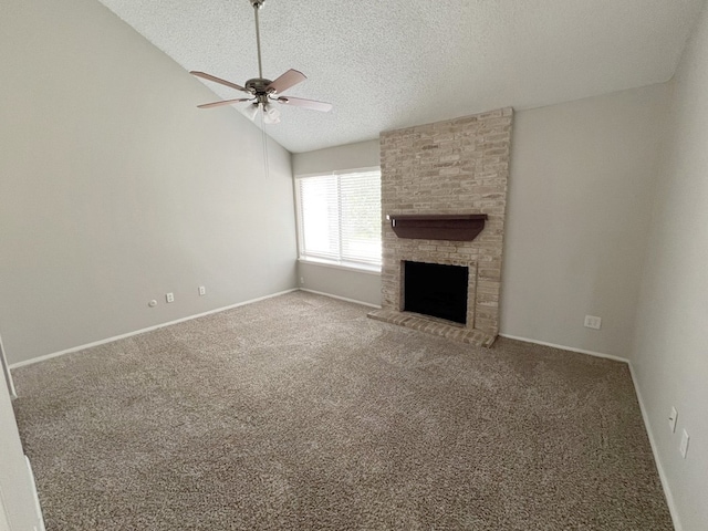 unfurnished living room featuring ceiling fan, a textured ceiling, a fireplace, and carpet floors