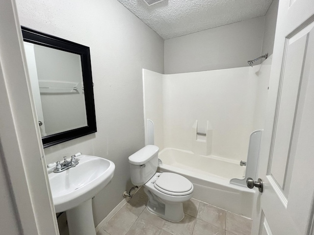 bathroom featuring tile patterned flooring, a textured ceiling, tub / shower combination, and toilet