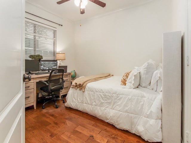 bedroom featuring ceiling fan, dark hardwood / wood-style floors, and crown molding