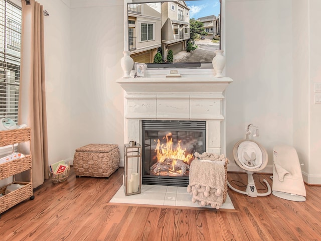 interior details with hardwood / wood-style floors and a tile fireplace