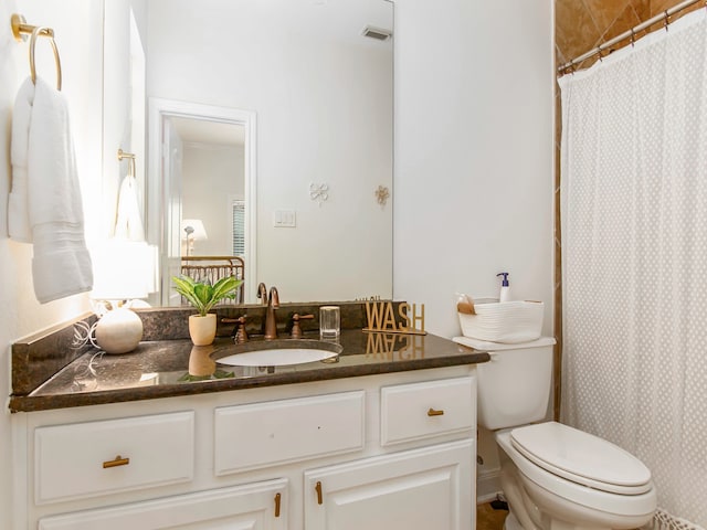 bathroom featuring vanity, toilet, and a shower with curtain