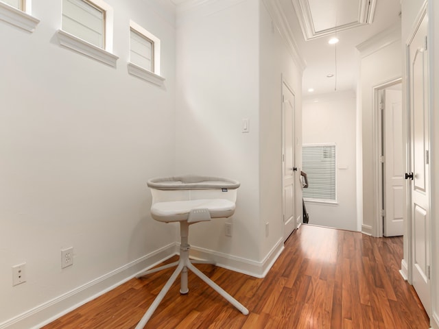 hall with dark hardwood / wood-style flooring and ornamental molding