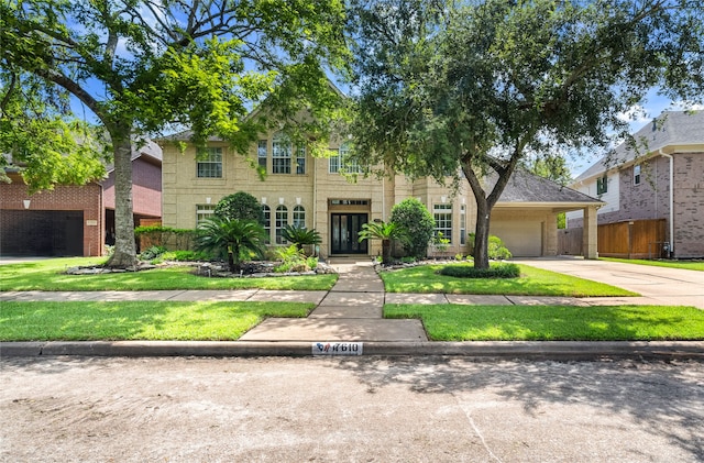 view of front of house featuring a garage and a front lawn