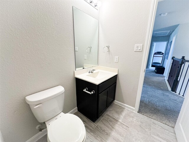 bathroom with tile patterned flooring, vanity, and toilet