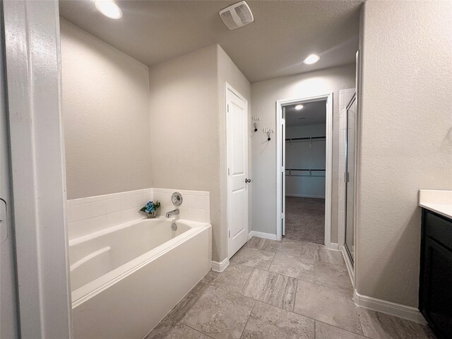 bathroom featuring vanity and plus walk in shower