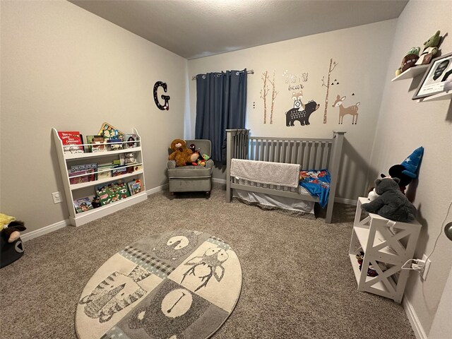 bedroom featuring a crib and carpet floors