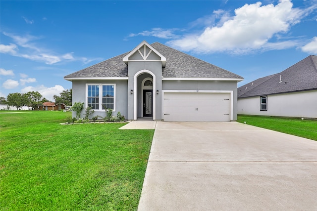 view of front of property with a front yard and a garage