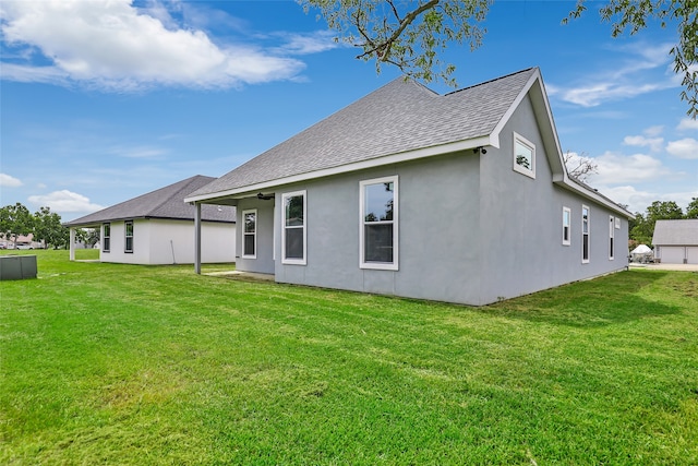 back of property featuring a yard