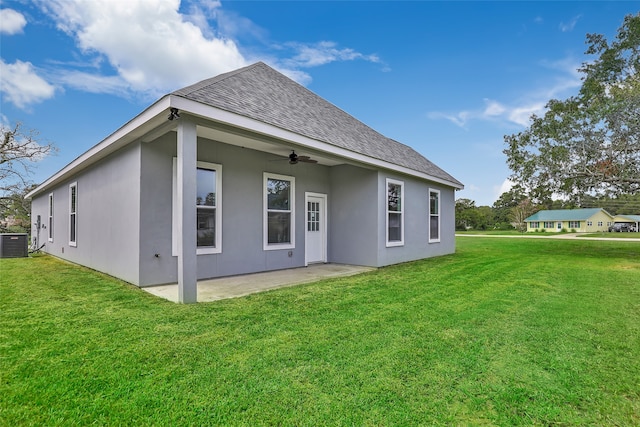 rear view of property featuring ceiling fan, a lawn, a patio, and central AC unit