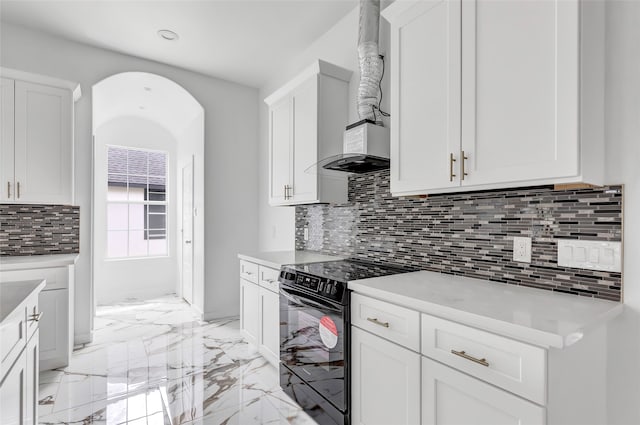 kitchen featuring white cabinets, black / electric stove, and decorative backsplash