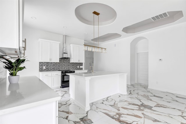 kitchen with a kitchen island with sink, pendant lighting, black electric range oven, wall chimney exhaust hood, and white cabinets