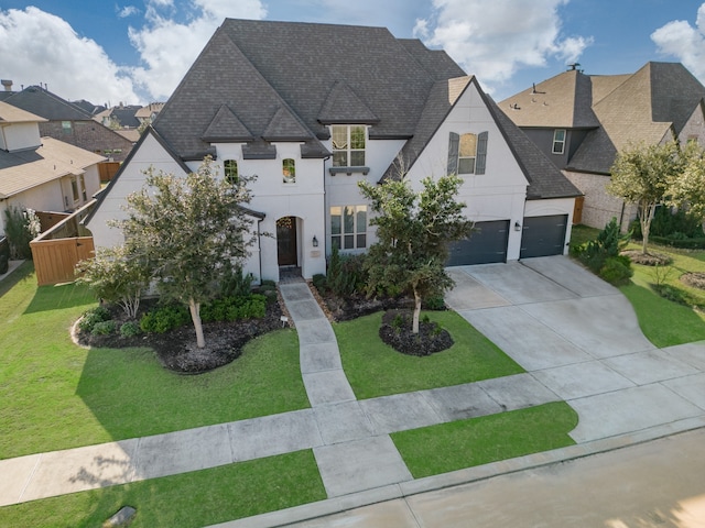 french provincial home with a garage and a front lawn