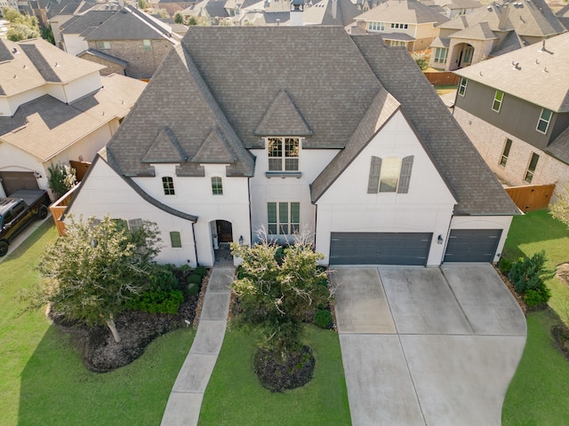 view of front of home featuring a front yard and a garage