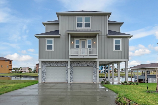 view of front of home with a water view, a garage, a front lawn, and a balcony