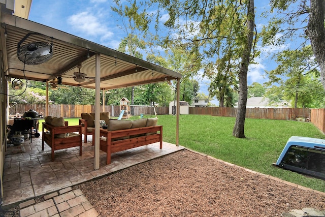 view of yard featuring a playground, ceiling fan, and a patio