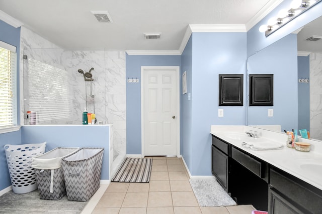 bathroom featuring vanity, a healthy amount of sunlight, tiled shower, and tile patterned flooring