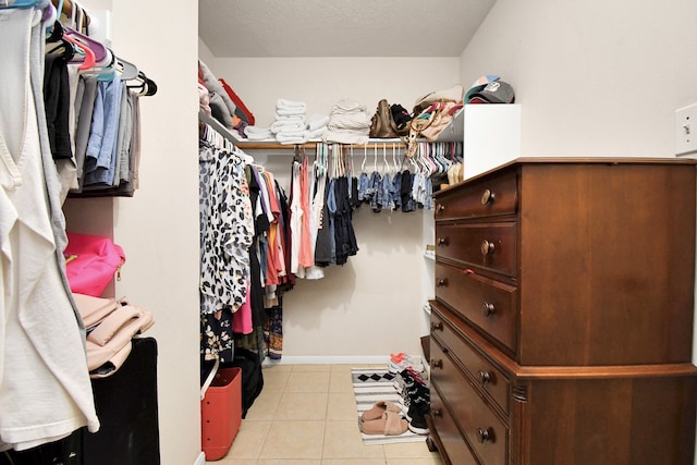 spacious closet featuring light tile patterned floors