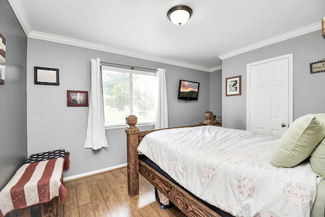 bedroom with ornamental molding and dark hardwood / wood-style flooring