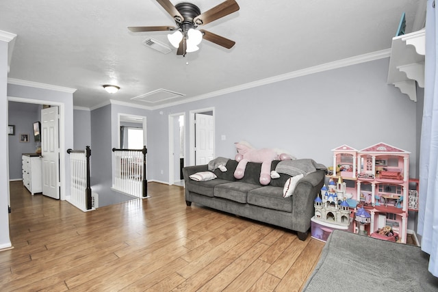 living room with ornamental molding, hardwood / wood-style flooring, and ceiling fan